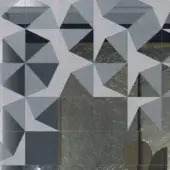 Geometric tile pattern in grey, white, and blue with marble veining, featuring starburst and triangular designs; “sicis prisma nude” detail.